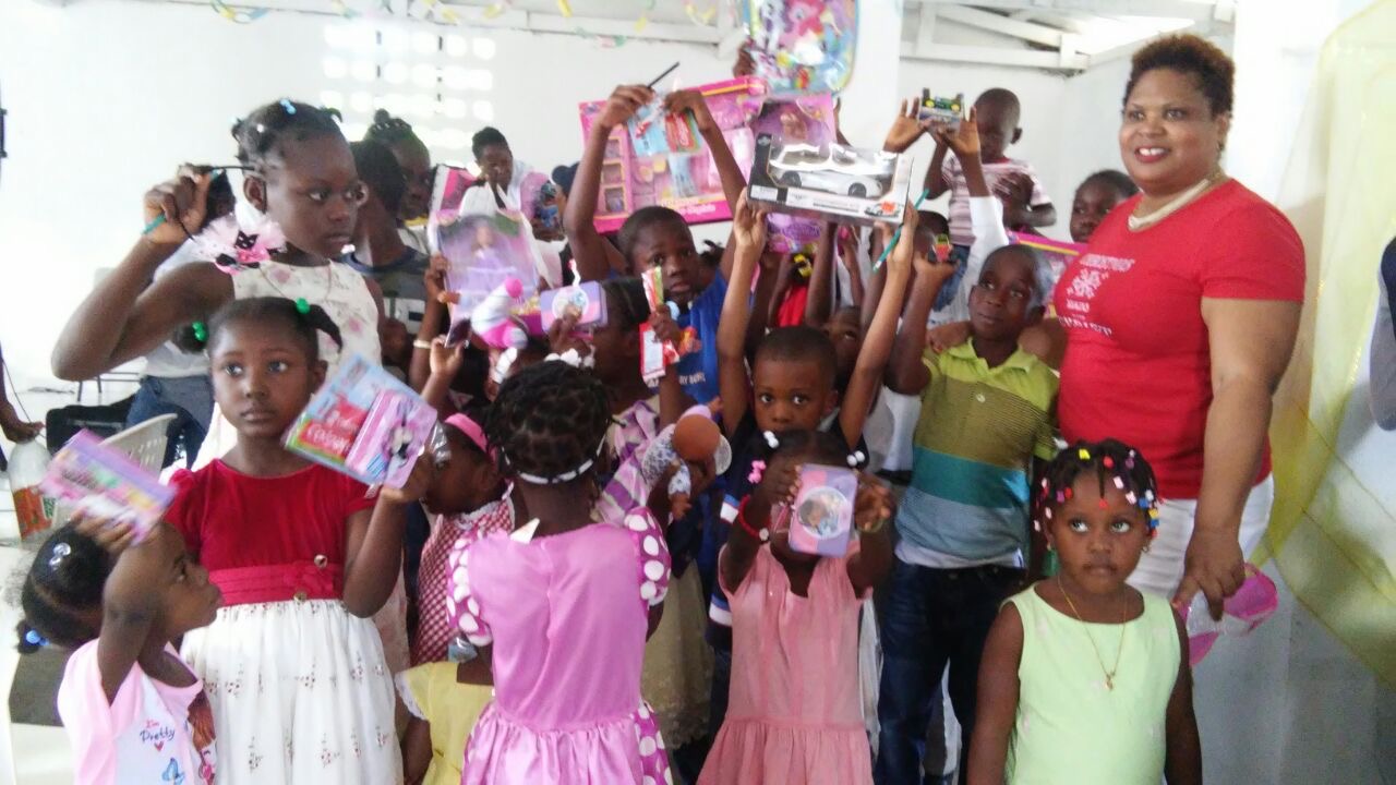 Children showing gifts received during outreach.