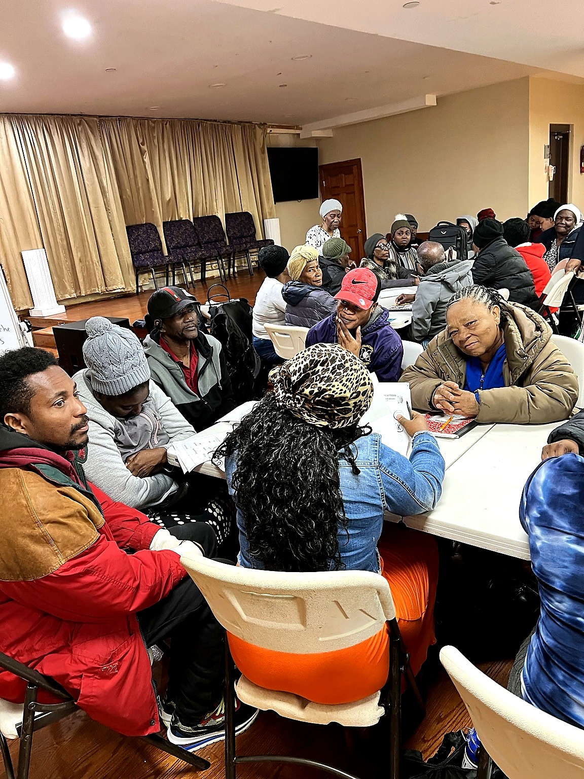 Adults practice English in a real classroom setting.
