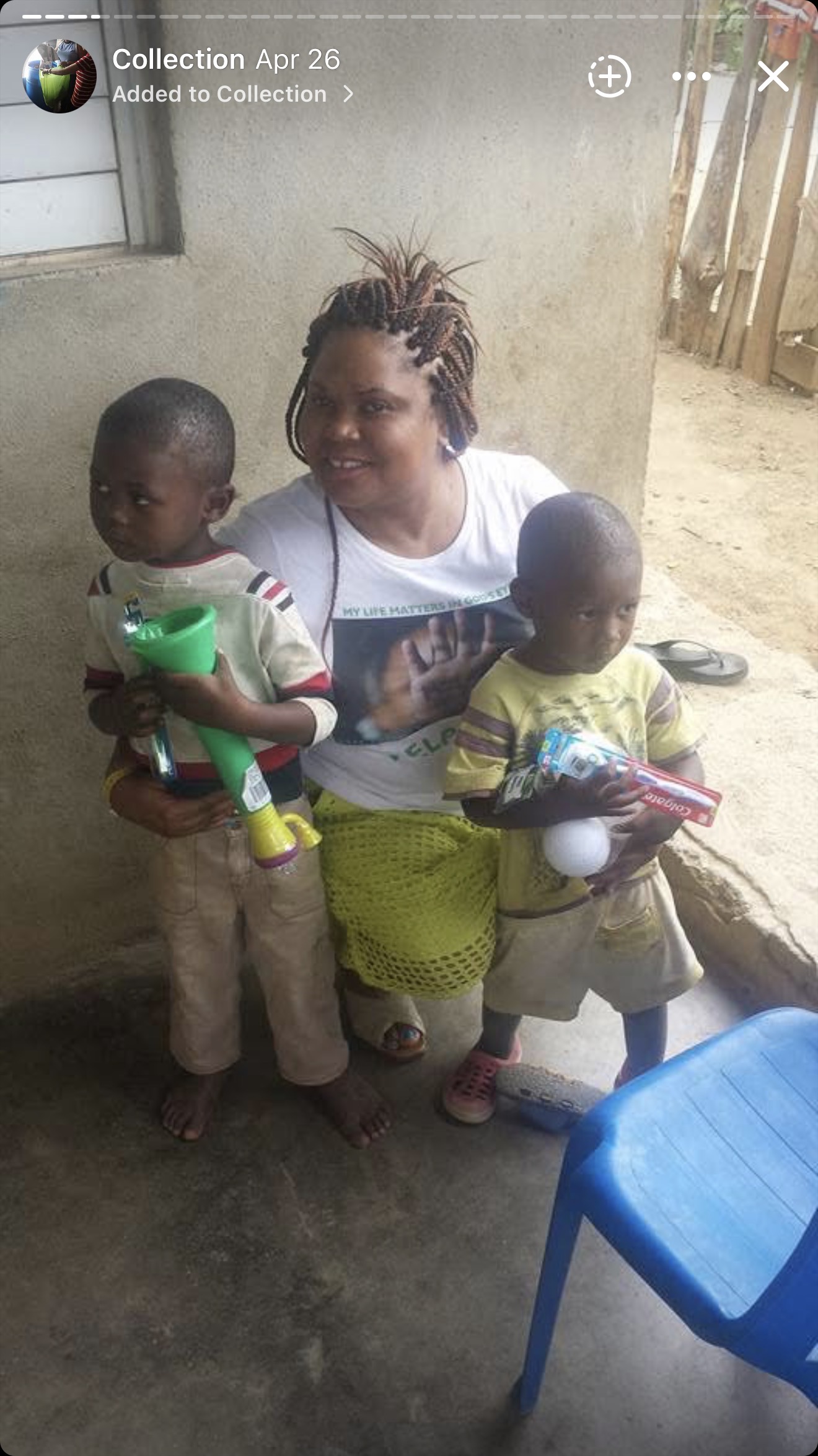 Renée Douyon joins two children holding personal-care supplies during a Foundation outreach activity.