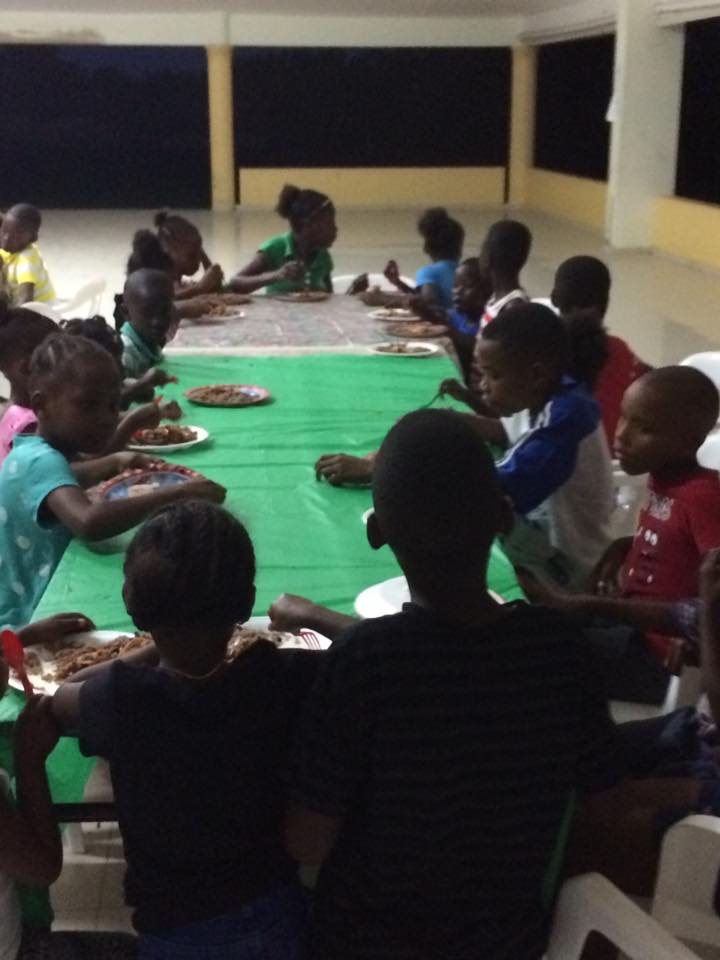 Children sharing a meal at a community gathering