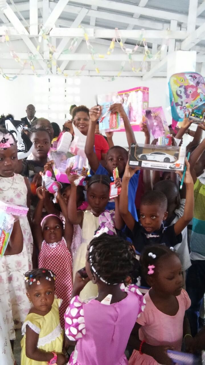 Children holding gifts during holiday outreach