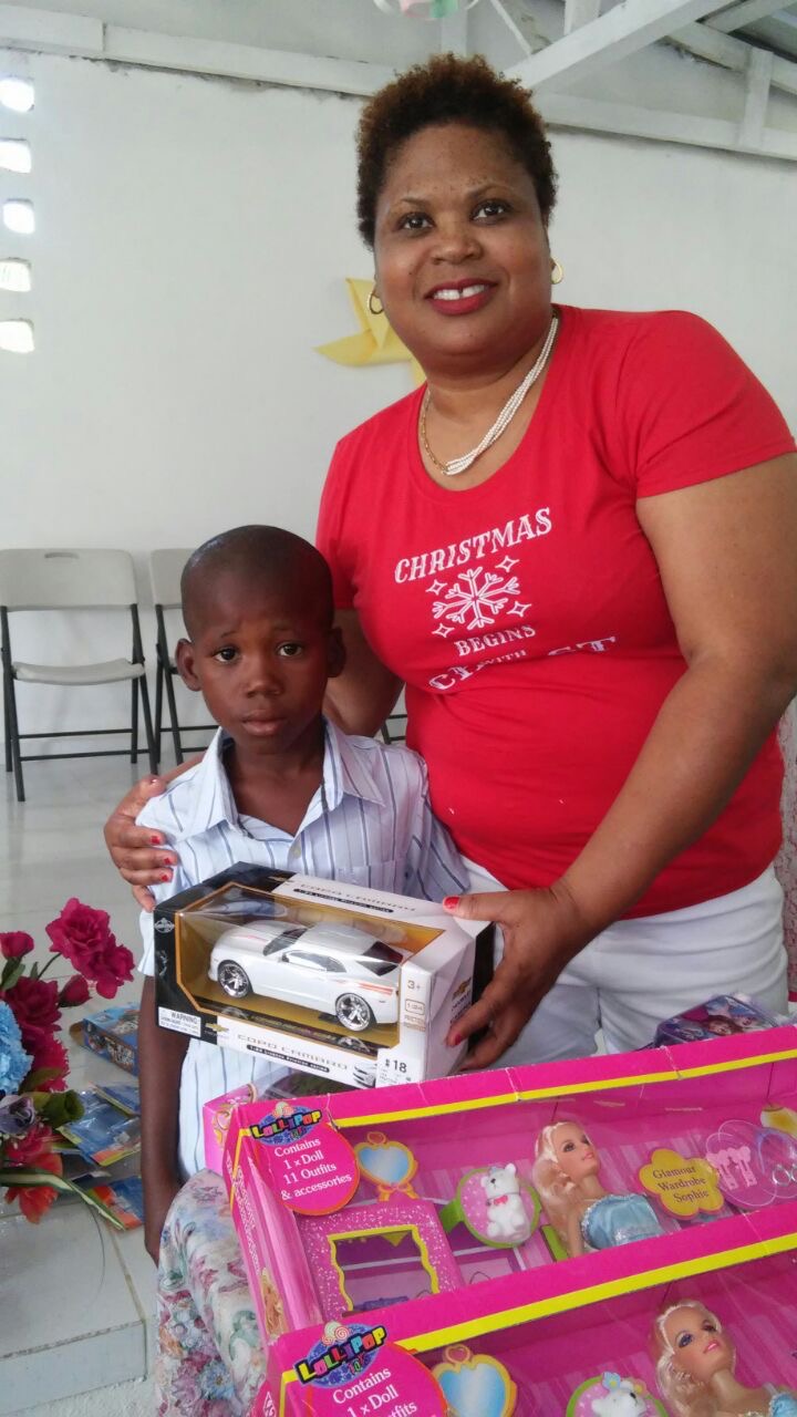 A young participant receives a gift and personal encouragement.