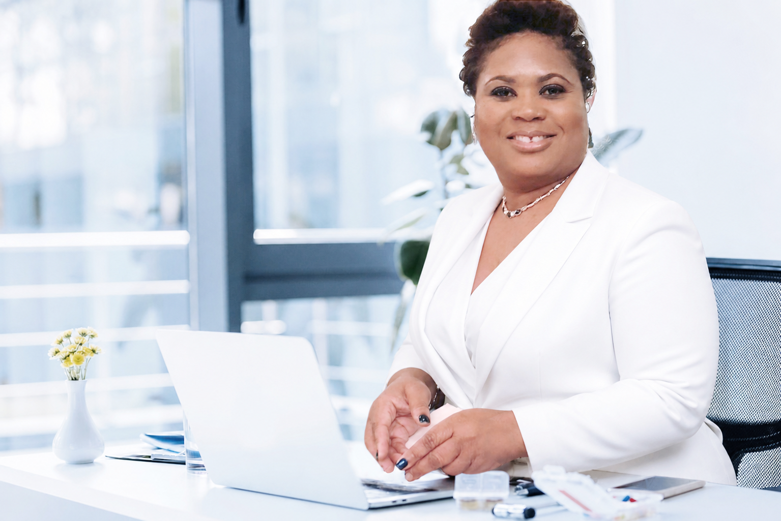 Founder Renée Douyon in a white suit